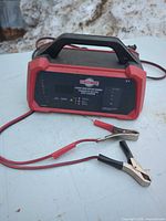 Front view of MotoMaster Classic Series battery charger with attached clamps