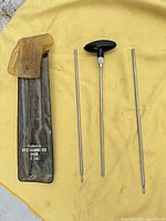 Complete Outers BP600 .22 cal cleaning rod kit laid out: pouch, three rod sections (one with handle)