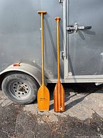 Both paddles leaning against trailer for full view