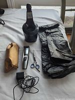 Full kit laid out including trimmer, SmartClean base, scissors, cape, pouch, adapter