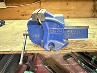 Full view of Record 210C bench vise on workbench