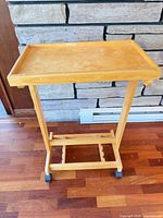 Angled view showing top surface, support, base, and casters