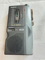 Front view showing cassette window, controls, speaker grille, counter