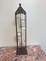 Full view of metal candle holder tower