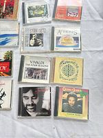 Group of CDs showing Vivaldi, Stan Getz, Celtic Seasons, Andrea Bocelli Sentimento, Quincy Jones Super Hits and others