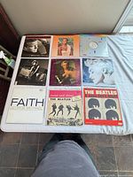 Nine LP sleeves laid out, front artwork visible