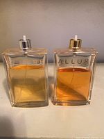 Front view of two Chanel Allure bottles showing liquid levels and sprayers