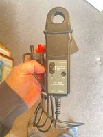 Front view showing model CP 305 label, selector switch, wired banana leads