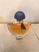 Front view of sealed 50 ml Guerlain Shalimar bottle with cap and ribbon