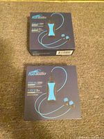 Two sealed retail boxes front view