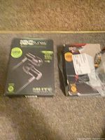 Front view of two ISOtunes earbud boxes on floor