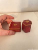 Both red jewellery boxes closed