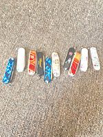 Ten Victorinox keychain knives lined horizontally showing colour variety