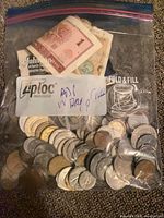 Ziploc bag filled with mixed coins and paper notes