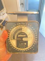 Front view of Pelouze K4 scale showing analog dial and brand