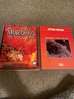 Both role-playing game books side by side