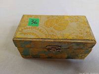 Closed brocade-covered box with latch