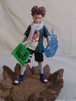 Front view of Choji Akimichi figure on rocky base with blue chakra effect