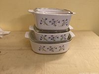 Stacked view of three Blue Dusk casseroles showing pattern and lids