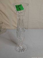 Full view of clear crystal vase with patterned cuts and footed base