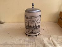 Front view of beer stein showing Düsseldorf skyline illustration and pewter lid
