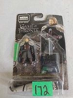 Front of sealed blister card showing Eddard Stark figure, sword, stand, and branding