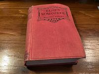 Closed book showing red cloth cover, spine with black stamping