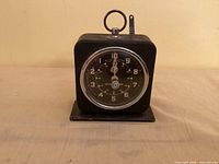 Front view showing dial, casing, mounting base