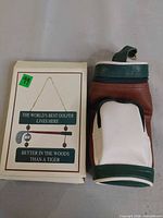 Golf bag style water bottle holder next to boxed golf wall sign