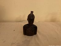 Front view of carved wooden bust