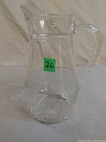 Front view showing entire clear glass juice pitcher