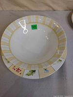 Top view of large salad bowl stacked on plate showing pattern