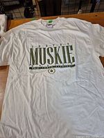 Front view of white Trophy Muskie T-shirt showing graphic and condition