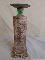 Full view of metal pedestal showing height, paint, rust, and design
