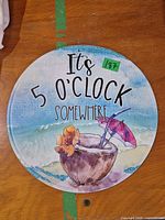 Front view of the round metal sign showing full artwork and text