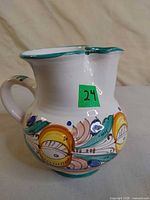 Left side view of hand-painted ceramic pitcher showing overall form and pattern