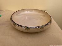 Top view of shallow cream glazed float bowl with decorative rim