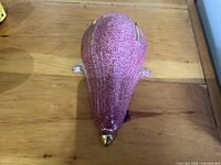 Overall view showing speckled pink glaze and gold accents of the wall pocket