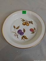 Top view showing fruit motif, gold rim