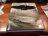 Front dust jacket showing bomber silhouette over coastline