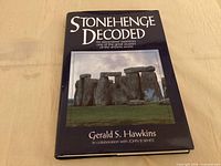Front of hardcover book with dust jacket showing title and Stonehenge image