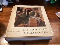 Front cover of The History of Impressionism hardcover book with dust jacket
