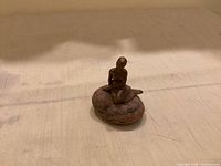 full view of miniature metal mermaid figurine on stone base