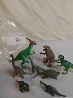 All eight toy dinosaur figures grouped together
