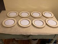 Eight Villa Cannes bread plates arranged on table