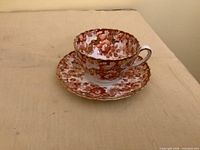 Teacup on saucer showing pattern and condition