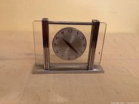 Front view showing glass panels, chrome frame, dial