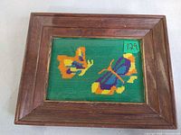 Front view of framed needlepoint with butterflies