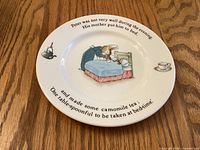 Top view of Peter Rabbit porcelain plate showing illustration and text