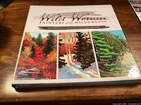 Front cover showing title and three landscape paintings